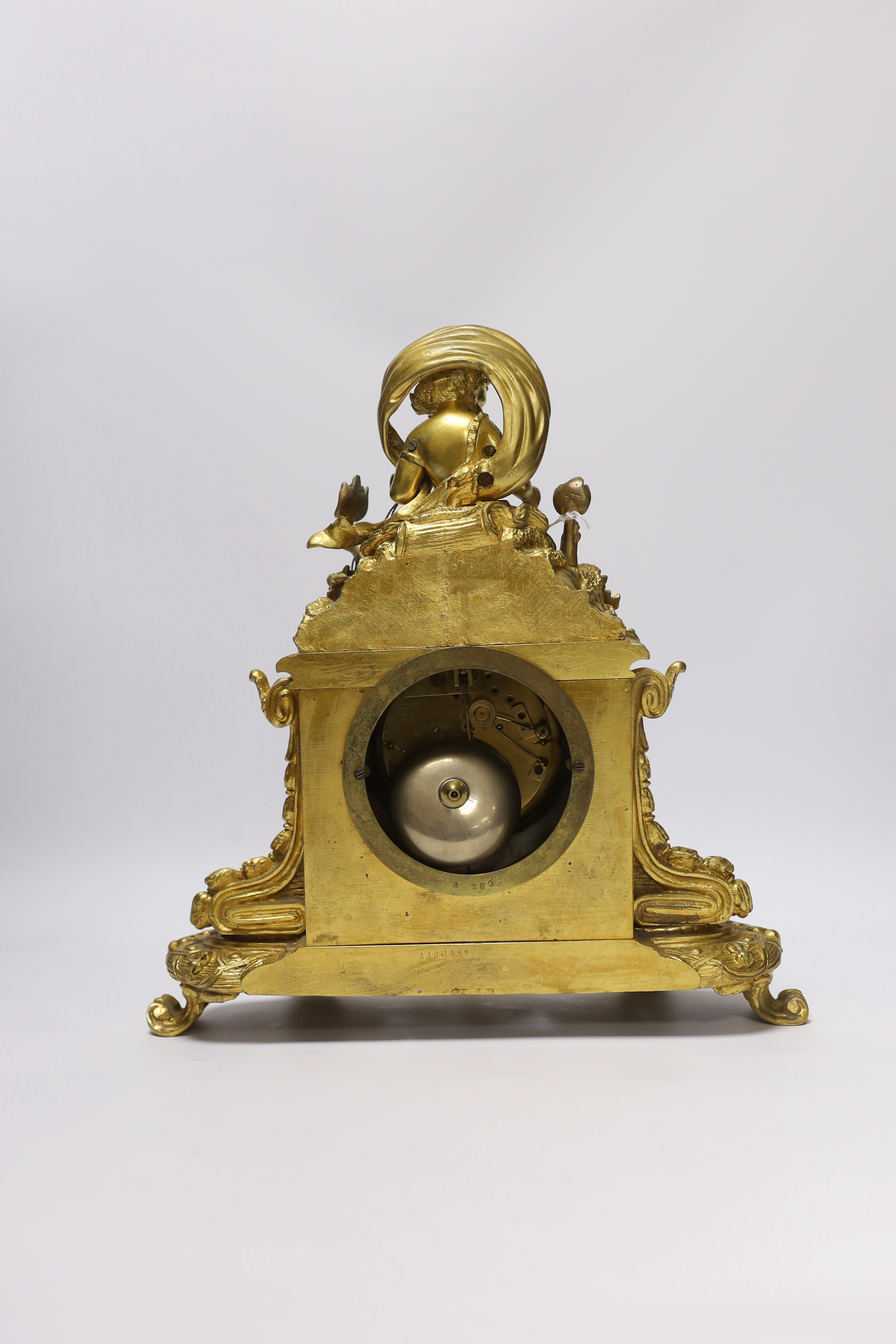 An early 20th century French ormolu mantel clock, with enamel dial, key and pendulum, 31cm